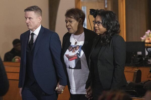 Jayland Walker Family attorney Bobby DiCello, left, and U.S. Congresswoman Emilia Sykes, D-Ohio, right, assist Pamela Walker, Jayland Walker's mother, to a media briefing Monday, April 17, 2023, at St. Ashworth Temple in Akron, Ohio, after a grand jury decision not to indict eight Akron police officers in the shooting death of Walker last summer. (AP Photo/Phil Long)
