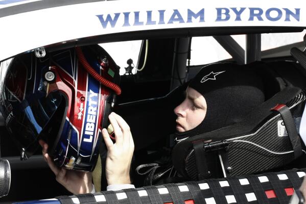 William Byron puts on his helmet during NASCAR cup series qualifying at Homestead-Miami Speedway, Saturday, Oct. 22, 2022, in Homestead, Fla. (AP Photo/Daryl Graham)