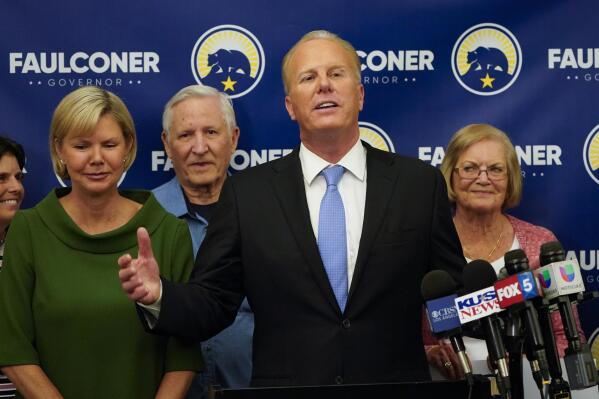 Kevin Faulconer, former San Diego mayor and Republican candidate for governor of California, speaks alongside his wife, Katherine Faulconer, left, at his campaign headquarters after polls closed in the recall election Tuesday, Sept. 14, 2021, in San Diego. Faulconer said his failed campaign to replace California Gov. Gavin Newsom was only his first round and that he would discuss next steps with family and supporters, but his drubbing in the recall contest casts serious doubt on the appeal of a moderate Republican in an overwhelmingly Democratic state. (AP Photo/Gregory Bull)