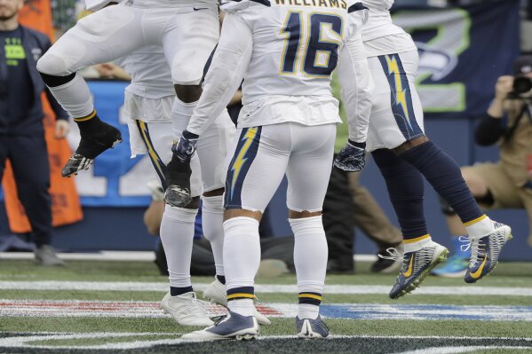 
              Los Angeles Chargers wide receiver Mike Williams, right, celebrates with running back Melvin Gordon, left, and wide receiver Tyrell Williams (16) after scoring a touchdown during the first half of an NFL football game against the Seattle Seahawks, Sunday, Nov. 4, 2018, in Seattle. (AP Photo/Ted S. Warren)
            