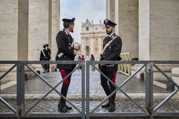 Italian Carabinieri paramilitary police stand beneath the Bernini Colonnade near St.Peter's Basilica where Pope Francis is lying in state, at the Vatican, Thursday, April 24, 2025. (AP Photo/Bernat Armangue)