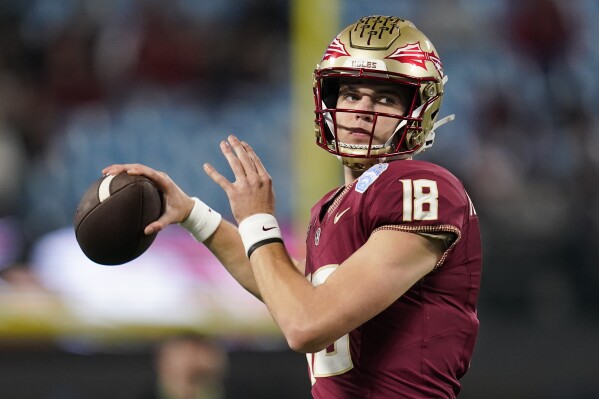 FILE - Florida State quarterback Tate Rodemaker warms up for the team' Atlantic Coast Conference championship NCAA college football game against Louisville, Saturday, Dec. 2, 2023, in Charlotte, N.C. Could the fourth-ranked Seminoles, with a victory against defending national champion and No. 6 Georgia in the Orange Bowl be voted No. 1 in the final Associated Press college football poll? While voters say they would be open-minded to it, the current state of college football’s postseason all but renders the conversation moot. (AP Photo/Erik Verduzco, File)