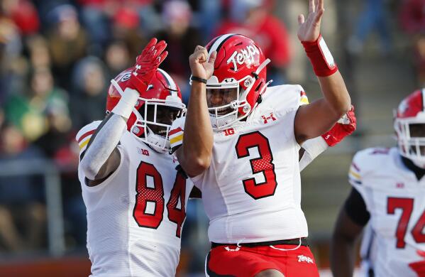 Maryland tight end Corey Dyches (84) and quarterback Taulia Tagovailoa (3) celebrate after a touchdown against Rutgers during the second half of an NCAA football game, Saturday, Nov. 27, 2021, in Piscataway, N.J. Maryland won 40-16. (AP Photo/Noah K. Murray)
