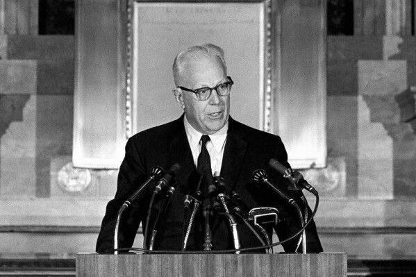 FILE - Chief Justice Earl Warren speaks at the Washington National Archives during a ceremony marking the 175th anniversary of congressional passage of legislation establishing the federal judicial system in the U.S., on Sept. 22, 1964. Seventy years ago, no one outside of the U.S. Supreme Court building heard it when Warren announced the historic Brown vs. Board of Education decision on school desegregation. Now, through the use of a voice-cloning technology, it is becoming possible for people to “hear” Warren read the decision as he did on May 17, 1954, along with oral arguments by lawyers. (AP Photo/Bill Allen, File)