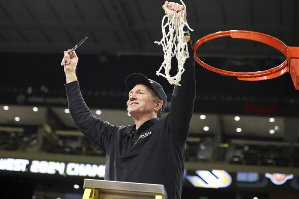 Long Beach State head coach Dan Monson participates in a net cutting ceremony after his team played an NCAA college basketball game against UC Davis in the championship of the Big West Conference men's tournament Saturday, March 16, 2024, in Henderson, Nev. Long Beach State won 74-70. (AP Photo/Ronda Churchill)