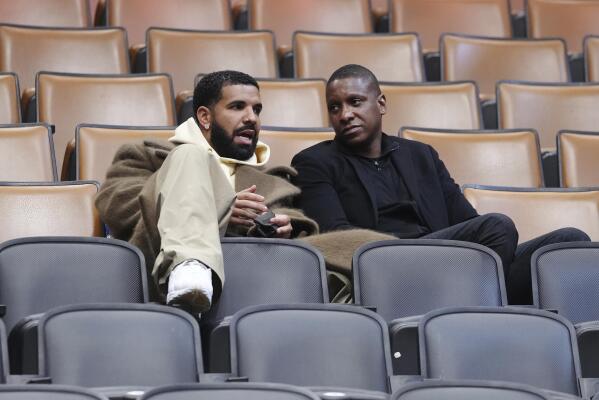 Toronto Raptors general manager Masai Ujiri, left, and rapper
