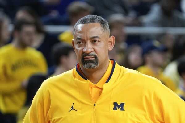 FILE - Michigan head coach Juwan Howard watches against Wisconsin in the first half of an NCAA college basketball game in Ann Arbor, Mich., on Feb. 26, 2023. Michigan basketball appears to be in a rebuilding mode, losing its top three scorers from last season. The Wolverines are unranked in the preseason AP Top 25 for the first time in four years. Giving the program one more challenge, coach Howard has been recovering from heart surgery since mid-September. (AP Photo/Paul Sancya, File)