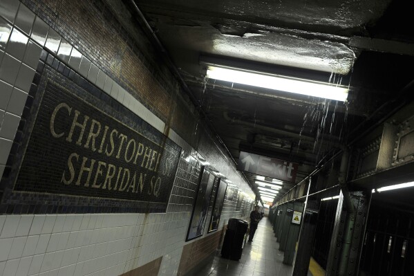 FILE - Rainwater seeps down into the Christopher Street-Sheridan Square subway station, March 30, 2010, in New York. The New York City subway station would be renamed to commemorate the Stonewall Inn protests that galvanized the modern LGBTQ rights movement, under legislation approved by state lawmakers as they wrapped up their session in June 2024. (AP Photo/Stephen Chernin, File)
