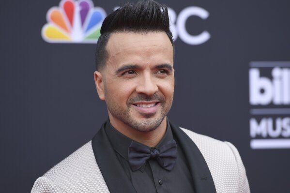 FILE - In this May 20, 2018 file photo, Luis Fonsi arrives at the Billboard Music Awards in Las Vegas. Telemundo is offering a first-of-its-kind virtual music special on Spanish-language media, featuring stars such as J Balvin, Luis Fonsi, Alejandro Sanz and Gloria Estefan.“Concierto en Casa” will air Saturday at 7 p.m. Eastern on Telemundo Network, UNIVERSO and across all its platforms. (Photo by Jordan Strauss/Invision/AP, File)