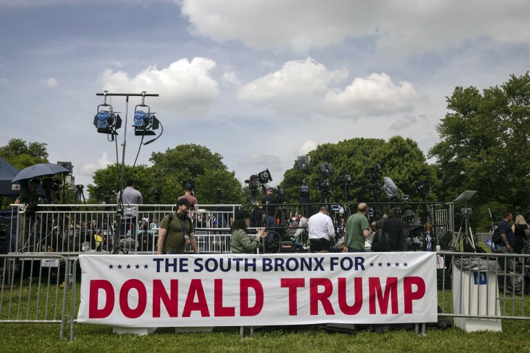 A banner in support of Republican presidential candidate former President Donald Trump is set up before a campaign rally in the Bronx borough of New York, Thursday, May. 23, 2024. (AP Photo/Yuki Iwamura)