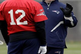 FILE - In this Dec. 14, 2011, file photo, New England Patriots offensive coordinator/quarterbacks coach Bill O'Brien talks with quarterback Tom Brady (12) during NFL football practice in Foxborough, Mass. O'Brien's agent said he was interviewing Thursday, Jan. 5, 2012, for the vacant Penn State head-coaching position. (AP Photo/Stephan Savoia, File)