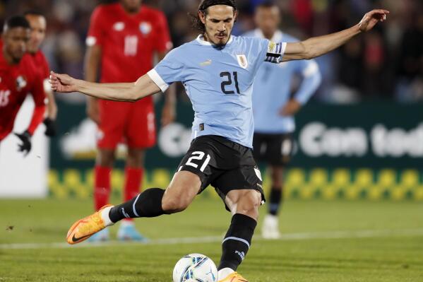 FILE - Uruguay's Edinson Cavani (21) kicks a penalty shot and scores during a friendly soccer match against Panama at Centenario Stadium in Montevideo, Uruguay, June 11, 2022. Valencia said Monday, Aug. 29, 2022, it signed veteran Uruguay striker Cavani on a two-year contract. (AP Photo/Matilde Campodonico, File)