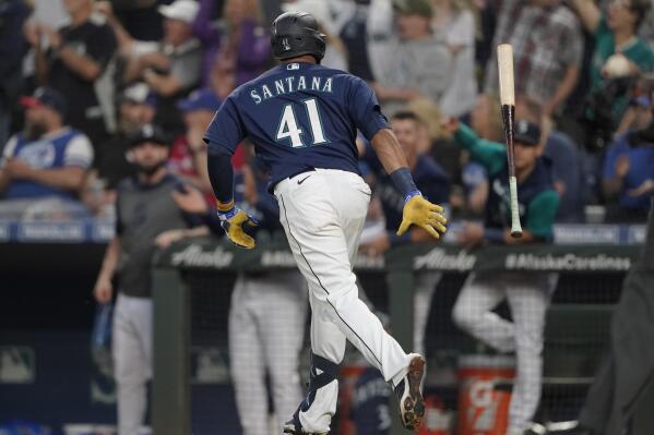 Seattle Mariners' Carlos Santana tosses his bat after he hit a two-run home run during the seventh inning of the team's baseball game against the Toronto Blue Jays, Saturday, July 9, 2022, in Seattle. (AP Photo/Ted S. Warren)