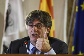 ADDS SECOND SENTENCE. FILE - Catalan leader Carles Puigdemont speaks at a press conference in Alghero, Sardinia, Italy, Oct. 4, 2021. Puigdemont says that he will return to Spain for the first time since leading a failed 2017 breakaway bid if he has a viable chance to be restored as regional president following upcoming elections. Puigdemont is still a wanted man in Spain and hoping that a contentious amnesty bill that was crafted by Spain’s left-wing government to clear him and hundreds of other supporters successfully makes it through the Madrid parliament in the coming months. (AP Photo/Gloria Calvi, File)