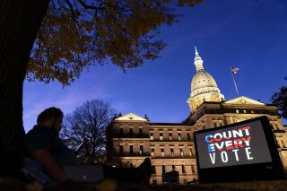 FILE - In this Nov. 6, 2020, file photo, the phrase "Count Every Vote" is displayed on a large screen, organized by an advocacy group in front of the State Capitol in Lansing, Mich. Social media users this week are falsely claiming that the release of sample 2022 primary election data by at least two news stations in Michigan is proof of fraud. The randomly-generated numbers were not real election results, and were accidentally published during a routine system test ahead of the August 2, 2022, primary. (AP Photo/David Goldman, File)