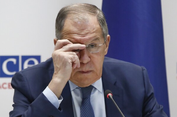 Russia's Foreign Minister Sergey Lavrov adjusts the glasses during his news conference at the time of the OSCE (Organization for Security and Co-operation in Europe) Ministerial Council meeting, in Skopje, North Macedonia, on Friday, Dec. 1, 2023. (AP Photo/Boris Grdanoski)