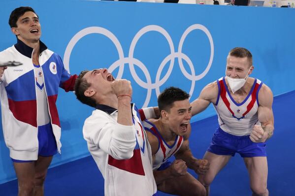 Russian Olympic Committee's artistic gymnastics men's team, from right, Denis Abliazin, right, Nikita Nagornyy, David Belyavskiy and Artur Dalaloyan celebrate after winning the gold medal at the 2020 Summer Olympics, Monday, July 26, 2021, in Tokyo. (AP Photo/Gregory Bull)