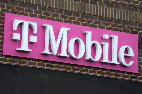 FILE - The sign for a T-Mobile store is seen, Jan. 30, 2023, in Pittsburgh. T-Mobile plans to cut 5,000 jobs, or about 7% of its workforce, the U.S. wireless carrier announced Thursday, Aug. 24. (AP Photo/Gene J. Puskar, File)