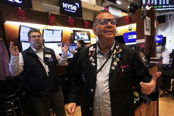 Trader Jonathan Mueller, right, Michael Capolino works on the floor of the New York Stock Exchange on Wednesday, May 14, 2025 (AP Photo/Richard Drew)