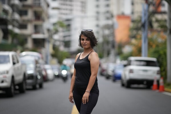 Elham Ghaedi, a migrant from Iran, poses for a portrait in Panama City, Monday, March 10, 2025, after being deported from the United States, detained for weeks in a Panamanian immigration camp, and released on a temporary humanitarian visa allowing a 30‑day stay. (AP Photo/Matias Delacroix)
