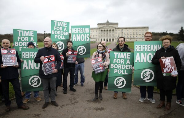 Anti-Brexit protesters gather outside Parliament buildings in Belfast, Northern Ireland, Friday, Jan. 31, 2020. Britain officially leaves the European Union on Friday after a debilitating political period that has bitterly divided the nation since the 2016 Brexit referendum. (AP Photo/Peter Morrison)