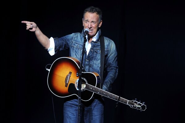 FILE - In this Nov. 5, 2018, file photo, Bruce Springsteen performs at the 12th annual Stand Up For Heroes benefit concert at the Hulu Theater at Madison Square Garden in New York. Iconic artists Lin-Manuel Miranda, Jon Bon Jovi and Bruce Springsteen are among the stars who will highlight a primetime virtual celebration televised Wednesday night following President-elect Joe Biden’s inauguration.(Photo by Brad Barket/Invision/AP, File)