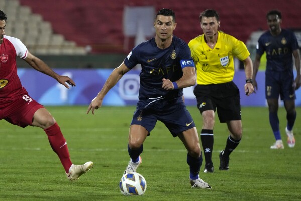 Saudi Arabia's Al Nassr Cristiano Ronaldo runs for the ball in a soccer match with Iran's Persepolis during an AFC Champions League soccer match at the Azadi Stadium in Tehran, Iran, Tuesday, Sept. 19, 2023. Al Nassr won the match 2-0. (AP Photo/Vahid Salemi)