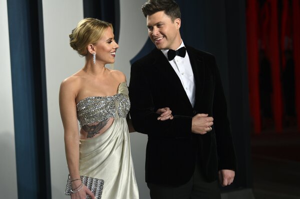 FILE - In this Feb. 9, 2020 file photo, Scarlett Johansson, left, and Colin Jost arrive at the Vanity Fair Oscar Party in Beverly Hills, Calif.  Meals on Wheels America announced Thursday on Instagram that Johansson and Jost married over the weekend in an intimate ceremony. (Photo by Evan Agostini/Invision/AP, FIle)