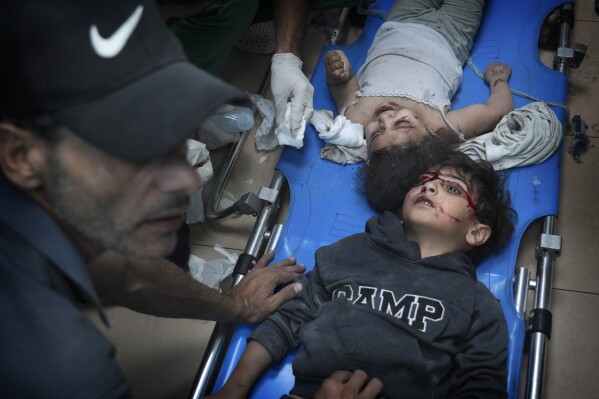 Palestinians wounded in the Israeli bombardment of the Gaza Strip are brought to a hospital in Deir al-Balah on Wednesday, Nov. 15, 2023. (AP Photo/Hatem Moussa)