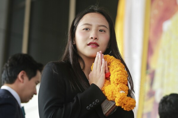 Parliament member Rukchanok Srinork of Thailand's opposition Move Forward party arrives at criminal court for the verdict for allegedly violating the lese majeste law in Bangkok, Thailand, Wednesday, Dec. 13, 2023. A court in Thailand convicted and sentenced Wednesday the recently elected lawmaker to six years in prison for defaming the monarchy under a controversial law that guards the royal institution. (AP Photo/Sopha Saelee)