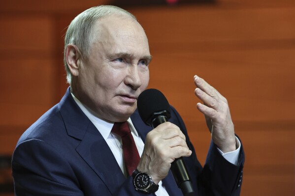 Russian President Vladimir Putin gestures while speaking to students and teachers of the new Secondary Special Music School at the Sirius Park of Science and Art after his phone talk with U.S. President Donald Trump, outside Sochi, Russia, on Monday, May 19, 2025. (Alexander Kazakov, Sputnik, Kremlin Pool Photo via AP)