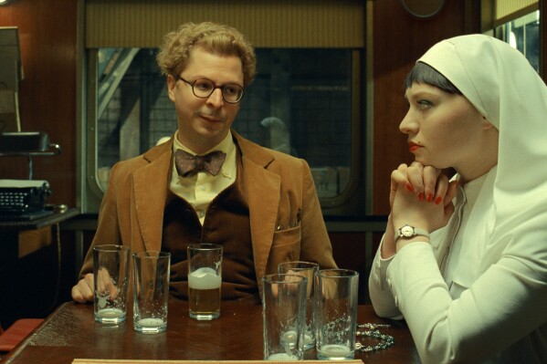 This image released by Focus Features shows Michael Cera, left, and Mia Threapleton in a scene from "The Phoenician Scheme." (TPS Productions/Focus Features via AP)