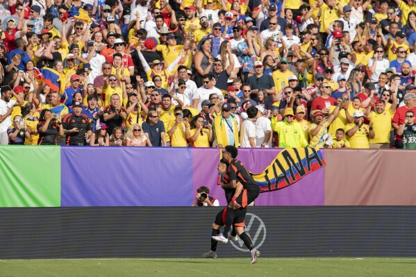 Colombia forward Rafael Santos Borré carries forward Luis Díaz (7) after a goal against the United States during the first half of an international friendly soccer match Saturday, June 8, 2024, in Landover, Md. (AP Photo/Jose Luis Magana)