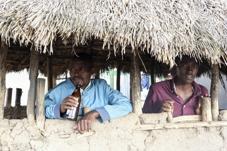 Benson Muhereza enjoys tonto at a local bar in Majengo village, Mbarara, Uganda, Dec. 10, 2023.  (AP Photo/Hajarah Nalwadda)