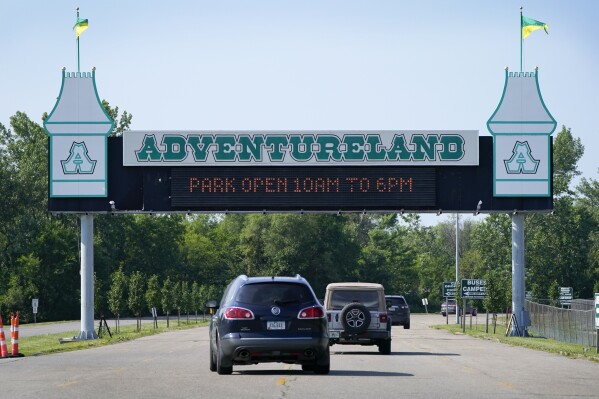 Visitors arrive at the Adventureland Park amusement park, Tuesday, July 6, 2021, in Altoona, Iowa. (AP Photo/Charlie Neibergall, File)