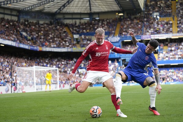 Chelsea's Enzo Fernandez, right, and Nottingham Forest's Joe Worrall vie for the ball during the English Premier League soccer match between Chelsea and Nottingham Forest at Stamford Bridge stadium in London, Saturday, Sept. 2, 2023. (AP Photo/Kirsty Wigglesworth)