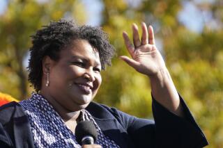 FILE - Stacey Abrams speaks to Biden supporters as they wait for former President Barack Obama to arrive and speak at a campaign rally for Biden at Turner Field in Atlanta, Nov. 2, 2020. Incumbent Gov. Brian Kemp is far outraising his main Republican primary challenger, former U.S. Sen. David Perdue, leaving Perdue with less than $1 million in cash on hand while Kemp had $12.7 million in his main campaign account. Democrat Abrams raised $9.25 million after entering the race only a few days ahead of Perdue. (AP Photo/Brynn Anderson, File)