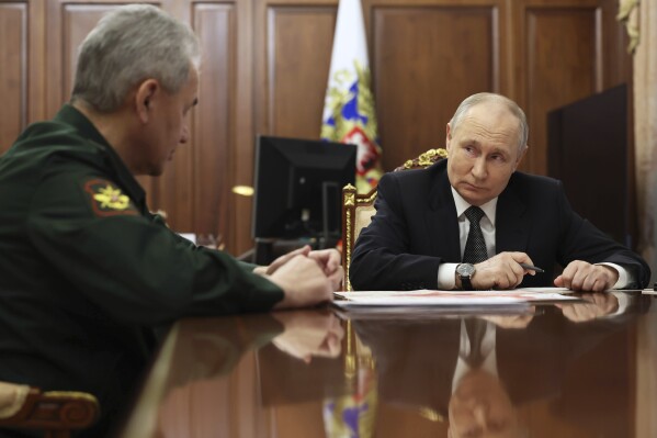 Russian President Vladimir Putin, right, listens to Russian Defense Minister Sergei Shoigu during their meeting at the Kremlin in Moscow, Russia, Tuesday, Feb. 20, 2024. (Alexander Kazakov, Sputnik, Kremlin Pool Photo via AP)