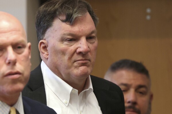 Rex Heuermann appears with his lawyer Michael J. Brown, left, at Suffolk County Court in Riverhead, N.Y., on Wednesday, Sept. 27, 2023. Heuermann was charged last month in the deaths of three women and is the prime suspect in a fourth. (James Carbone /Newsday via AP)