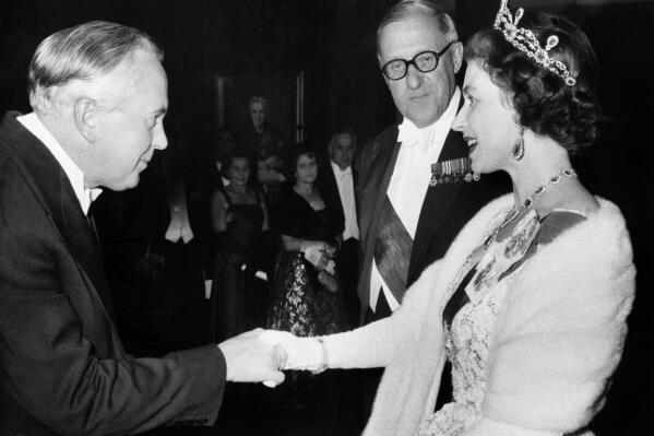 FILE - British Queen Elizabeth greets Prime Minister Harold Wilson at a reception in County Hall, Westminster, London on Nov. 11, 1964. In seven decades on the throne, Queen Elizabeth II saw 15 British prime ministers come and go, from Winston Churchill to Margaret Thatcher to Boris Johnson to Liz Truss.  (AP Photo, File)