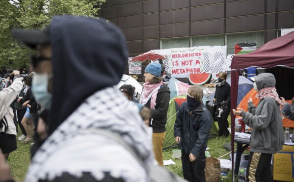 Participants stand during a pro-Palestinians demonstration by the group 'Student Coalition Berlin' in the theater courtyard of the 'Freie Universität Berlin' university in Berlin, Germany, Tuesday, May 7, 2024. Pro-Palestinian activists occupied a courtyard of the Free University in Berlin on Tuesday. (Sebastian Christoph Gollnow/dpa via AP)