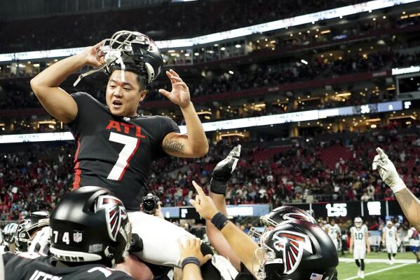 Atlanta Falcons place kicker Younghoe Koo is congratulated by teammates after kicking a field goal in overtime of an NFL football game to defeat the Carolina Panthers 37-34, Sunday, Oct. 30, 2022, in Atlanta. (AP Photo/John Bazemore)