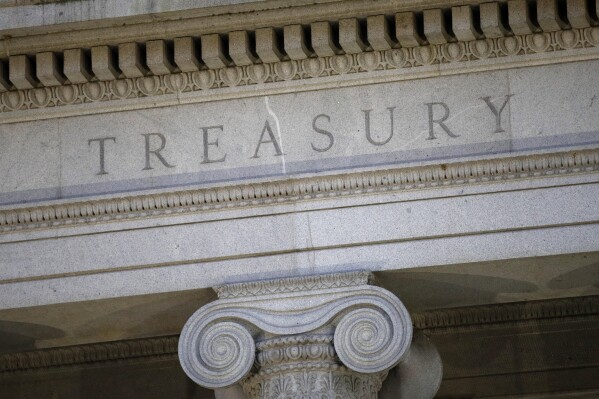 FILE- The U.S. Treasury Department building is shown at dusk in Washington on June 6, 2019. The U.S. on Tuesday, Dec. 5, 2023, imposed sanctions on a Belgian involved in procuring electronics for the Russian military, his companies and a group of Belarusian firms and people tied to Russia's invasion of Ukraine. (AP Photo/Patrick Semansky, File)