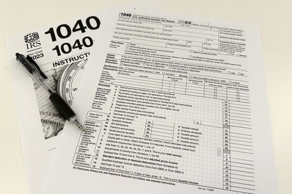 An Internal Revenue Service 2023 1040 tax form and instructions are shown on Friday, Jan. 26, 2024. For many people filing U.S. tax returns — especially those doing it for their first time — it can seem like a daunting task. (Ǻ Photo/Peter Morgan)