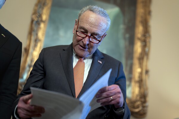 Senate Majority Leader Chuck Schumer, D-N.Y., looks over his notes during a meeting with Ukraine's Prime Minister Denys Shmyhal as Congress moves to advance an emergency foreign aid package for Israel, Ukraine and Taiwan, at the Capitol in Washington, Thursday, April 18, 2024. (AP Photo/J. Scott Applewhite)