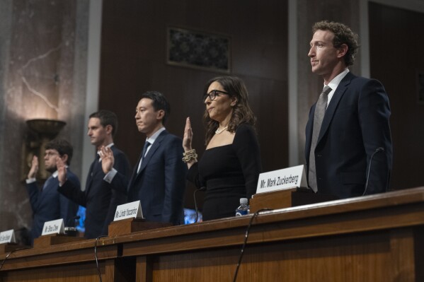 File - Left to right, Discord CEO Jason Citron, Snap CEO Evan Spiegel, TikTok CEO Shou Zi Chew, X CEO Linda Yaccarino and Meta CEO Mark Zuckerberg, are sworn in during a Senate Judiciary Committee hearing on Capitol Hill in Washington, Wednesday, Jan. 31, 2024, to discuss child safety. The CEOs got grilled by Senate lawmakers in an emotional and often heated hearing about the dangers their platforms pose to children. (AP Photo/Manuel Balce Ceneta, File)