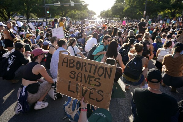 FILE - Demonstrators march and gather near the state capitol following the Supreme Court's decision to overturn Roe v. Wade, Friday, June 24, 2022, in Austin, Texas. A pregnant Texas woman whose fetus has a fatal diagnosis asked a court Tuesday, Dec. 5, 2023, to let her terminate the pregnancy, bringing what her attorneys say is the first lawsuit of its kind in the U.S. since Roe v. Wade was overturned last year. (AP Photo/Eric Gay, File)