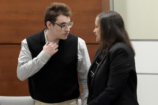 Marjory Stoneman Douglas High School shooter Nikolas Cruz speaks with sentence mitigation specialist Kate O'Shea, a member of the defense team, during the penalty phase of Cruz's trial at the Broward County Courthouse in Fort Lauderdale on Thursday, Aug. 25, 2022. Cruz previously plead guilty to all 17 counts of premeditated murder and 17 counts of attempted murder in the 2018 shootings. (Amy Beth Bennett/South Florida Sun Sentinel via AP, Pool)