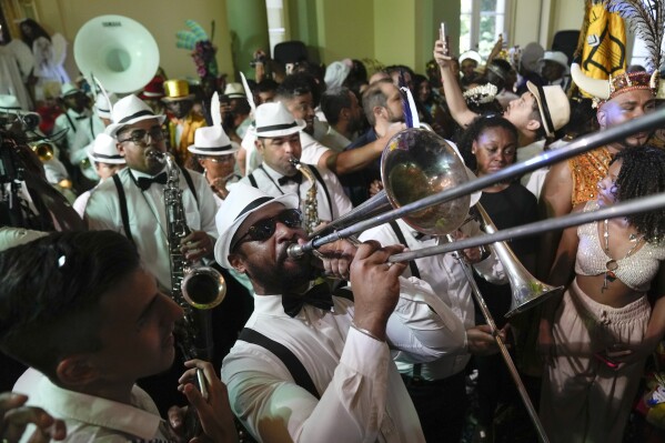 Musicians play during a ceremony that marks the official start of Carnival in Rio de Janeiro, Brazil, Friday, Feb. 9, 2024. (AP Photo/Silvia Izquierdo)