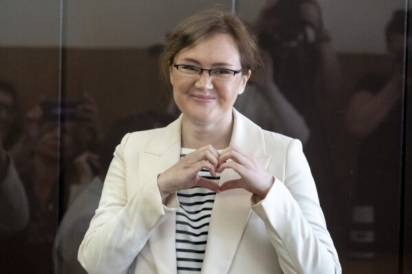 FILE - Lilia Chanysheva makes a heart gesture as she stands in a cage during a hearing in Kirovskiy District Court in Ufa, Russia, on Wednesday, June 14, 2023. (AP Photo, File)